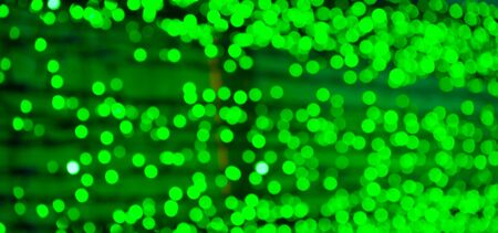 background of sparkling defocused and blurred light abstract bokeh green color with glitter circles with no peopleの写真素材