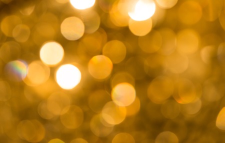 background of sparkling defocused and blurred light abstract bokeh golden yellow color with glitter circles with no peopleの写真素材