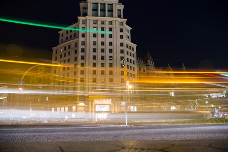 evening city with building house and bright light illumination as blurred lines in speed on road on black sky background outdoorのeditorial素材