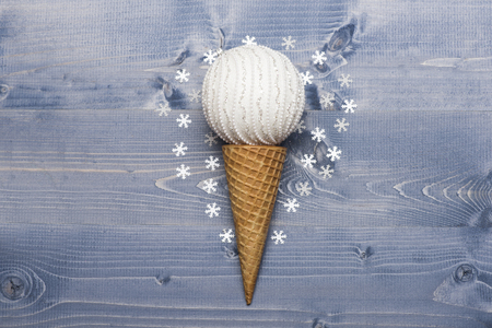 Decorated Christmas gift with white ball, snowflakes, ice cream cone on vintage wooden background.の写真素材