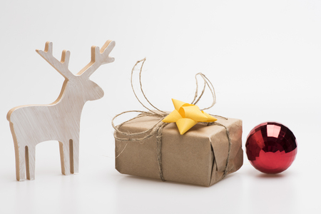 Christmas decorations including gift with yellow bow, christmas deer, red christmas ball isolated on white background.の写真素材