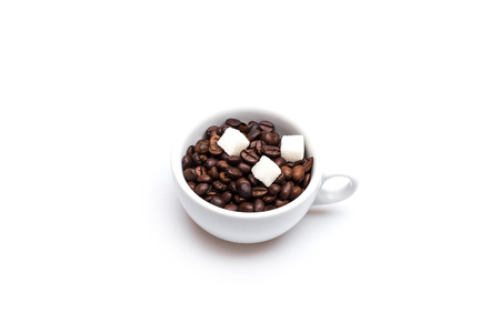 Roasted coffee beans and sugar cubes in a white ?up on white background. Top viewの写真素材