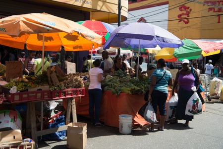 Port of spain, Trinidad and Tobago - November 28, 2015: busy local south market of vegetables and fruit with people outdoors on sunny summer day on streetscape backgroundのeditorial素材