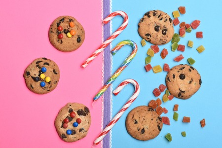 Set of chocolate chip cookies with colorful dragee, marmalade or jelly candies, striped caramel...