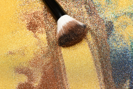 Soft cosmetics brush on golden background, makeup conceptの写真素材