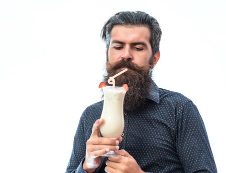 handsome bearded man with stylish hair mustache and long beard holding and looking on glass of nonalcoholic cocktail isolated on whiteの写真素材