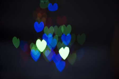Colorful hearts bokeh background of love symbol. Blurred light with heart abstract background.の写真素材