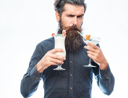 handsome bearded man with stylish hair mustache and long beard on serious face holding glass of...