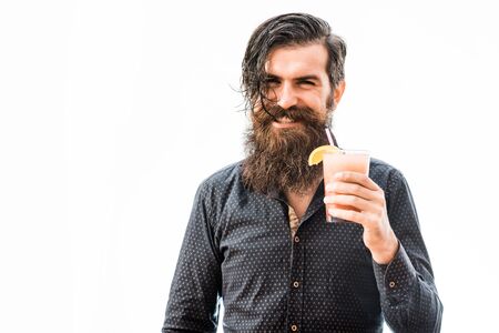 handsome bearded man with stylish hair mustache and long beard on smiling face holding glass of nonalcoholic cocktail isolated on white, copy spaceの写真素材