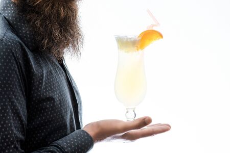 bearded man with lush beard holding glass of nonalcoholic cocktail with orange isolated on white, copy spaceの写真素材