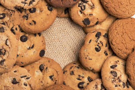 Tasty chocolate chip cookies mixed with oatmeal cookies on sack background, copy spaceの写真素材