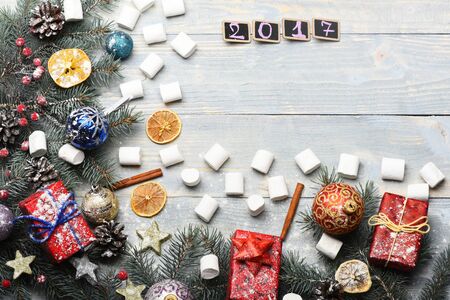 set of christmas or new year decoration with green fir tree with silver golden stars, colorful presents or gifts with xmas balls and marshmallow on white vintage wooden background, copy spaceの写真素材