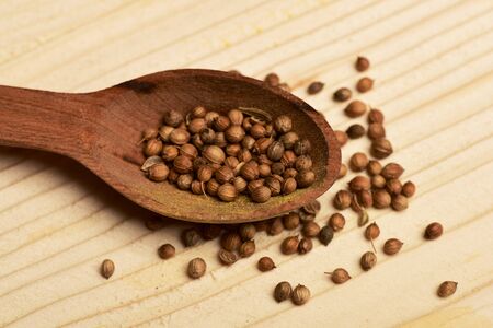 spicy fragrant coriander in spoon on vintage wooden background, side viewの写真素材