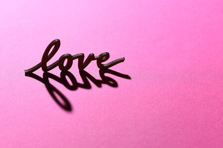 word love valentine inscription or exergue on pink background, copy spaceの写真素材
