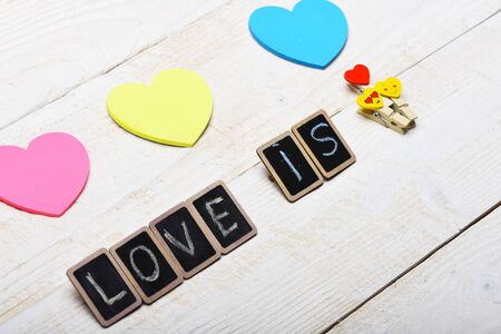 colorful pink blue yellow valentine card or hearts with word Love on little black boards and...