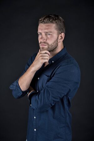 Young handsome fit businessmen standing on dark background, black and whiteの写真素材
