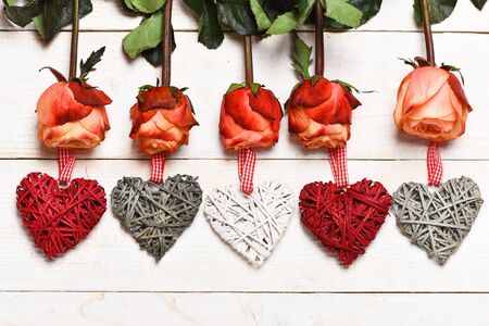 beautiful valentines day set with roses, bows, heart symbol on vintage wooden background, top viewの写真素材