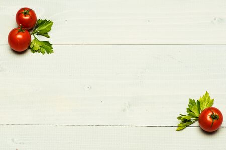 cherry tomatoes with parsley on white vintage wooden background, copy spaceの写真素材