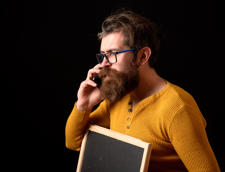 handsome bearded hipster man with long lush beard moustache and stylish hair on serious face in...