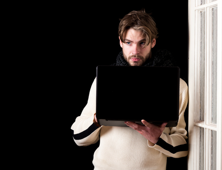 handsome bearded man or guy with beard on face in white sweater and knitted on black background near...