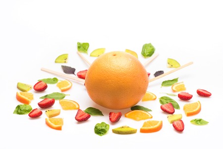 colorful sweet dessert of orange fruit, strawberry, kiwi and green mint leaves isolated on white background, copy spaceの写真素材