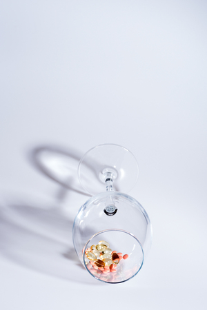 set of capsule and pills inside wineglass isolated on white background, copy space, side viewの写真素材
