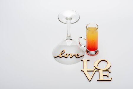 set of alcohol coctail sex on the beach with love inscriptions and wineglass isolated on white background, side viewの写真素材