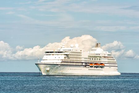 Large luxury cruise ship on sea water and cloudy sky background at sunny day at oceanのeditorial素材