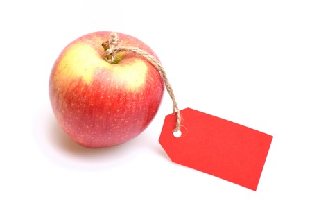 Fresh fruit of red apple with tag on rope isolated on white background, copy spaceの写真素材
