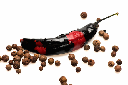 fresh vegetable, capsicum, allspice, chilly pepper, red, black color isolated on white backgroundの写真素材