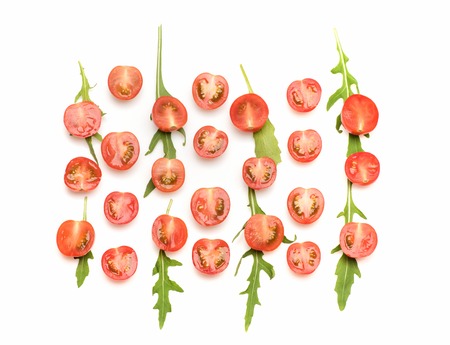 fresh vegetable, green arugula, cut cherry tomato red color isolated on white backgroundの写真素材