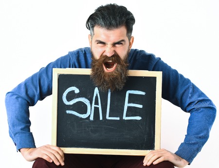 Bearded man, long beard. Brutal caucasian angry hipster with moustache holding sale inscription on...