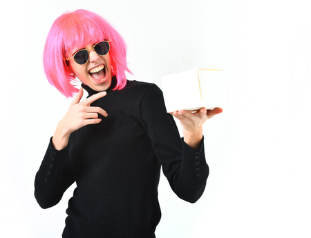 cute fashionable woman or pretty young smiling happy girl in pink wig and fashion glasses holding meal box isolated on white studio background, copy spaceの写真素材