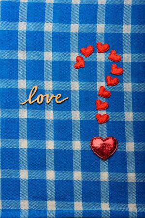 wooden word love and question mark made by red hearts symbol of love for valentines day holiday...