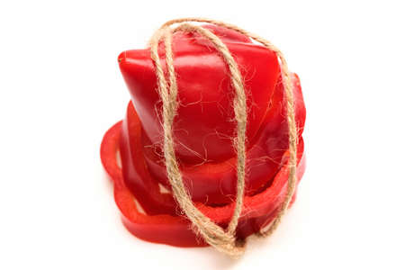 fresh vegetable, capsicum, sweet pepper, cut paprika red color in rope isolated on white backgroundの写真素材