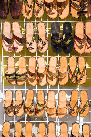 Cozumel, Mexico - December 24, 2015: leather hand made female slippers, flip flops or fashionable summer sandal brown color sale on shop stand or bazaar with nobody in Cozumel, Mexicoのeditorial素材