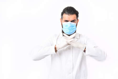 Bearded man, long beard. Brutal caucasian doctor or unshaven hipster, postgraduate student in mask, medical gown and gloves isolated on white studio background. Medicine conceptの写真素材