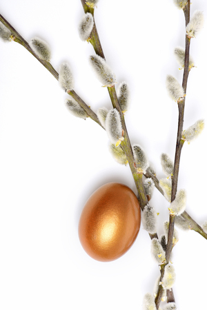 set of traditional egg painted in golden color with spring blossoming willow twigs isolated on white background. Happy Easter concept, luxury and successの写真素材