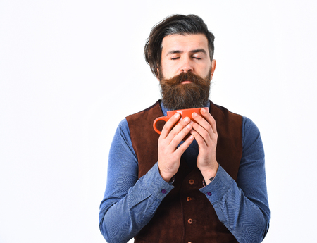 bearded man, long beard, brutal caucasian hipster with moustache holding mug or cup with coffee, tea with serious face isolated on white backgroundの写真素材