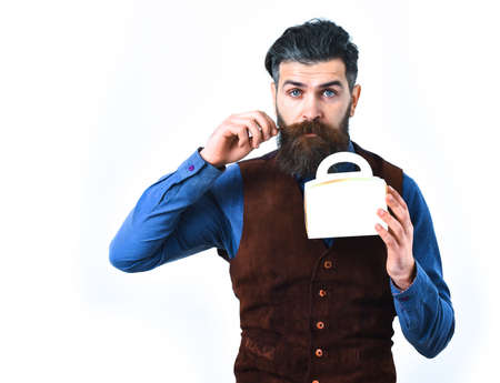 bearded man, long beard, brutal caucasian hipster with moustache holding lunch box with serious face isolated on white backgroundの写真素材
