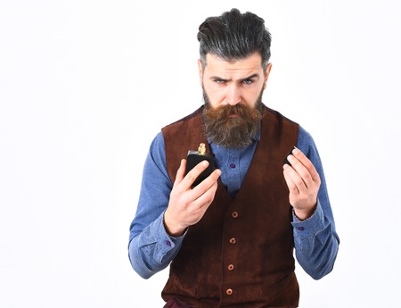 bearded man, long beard, brutal caucasian hipster with moustache holding perfume with serious face isolated on white backgroundの写真素材