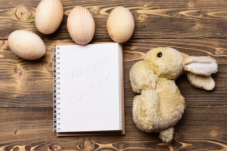wooden eggs, paper notebook, rabbit or hare toy, happy easter, cooking and eating, recipe and menu, healthy food, farming and agriculture, drawing and artの写真素材