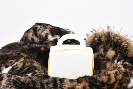 White carton meal box or container on spotted fluffy fur coat background, side viewの写真素材