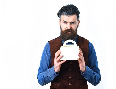bearded man, long beard, brutal caucasian hipster with moustache holding lunch box with serious face...