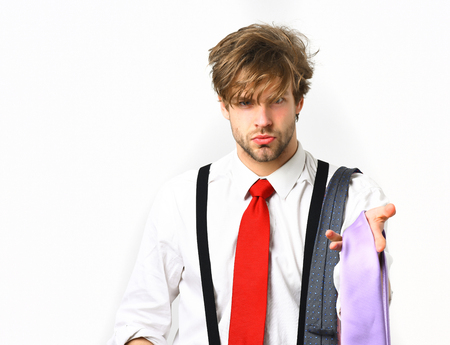 Bearded man, short beard. Caucasian bearded serious sexy macho with moustache holding colorful ties wearing white shirt with suspenders and red tie isolated on white backgroundの写真素材