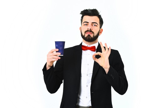 Bearded man, short beard. Caucasian serious hipster with moustache standing and holding blue plastic...
