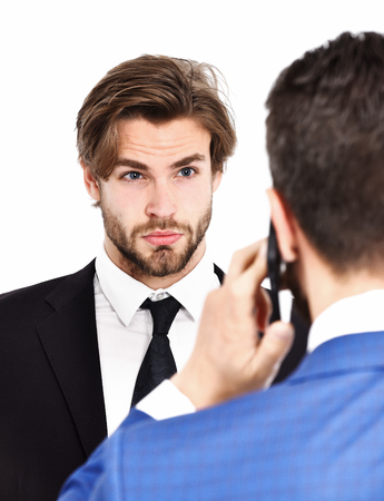 man with surprised face or businessmen speaking on mobile or cell phone in formal outfit isolated on whiteの写真素材