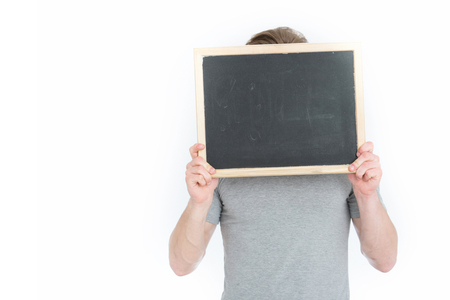 empty blackboard in hand of man or businessman standing isolated on white background, copy spaceの写真素材