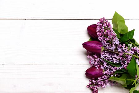 Bunch of lilac flowers with tulips on white vintage wooden background, copy spaceの写真素材