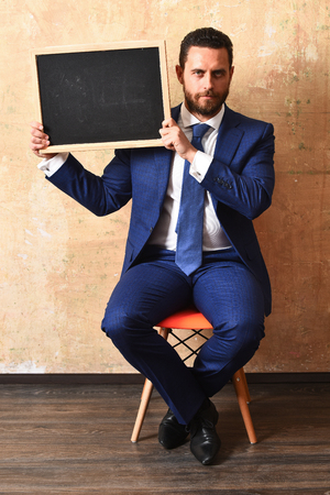 man and board. businessman holding a blackboardの写真素材